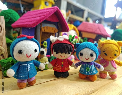 Felt dolls near miniature houses