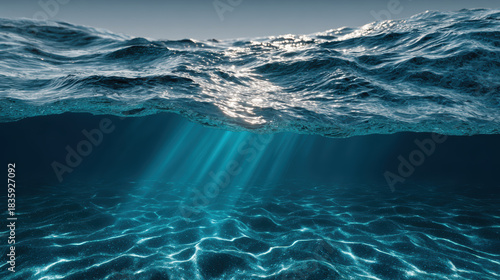 Fototapeta Naklejka Na Ścianę i Meble -  Serene underwater view of deep blue ocean surface with sun light rays beaming through clear water. peaceful liquid creates ripple texture on sea bottom