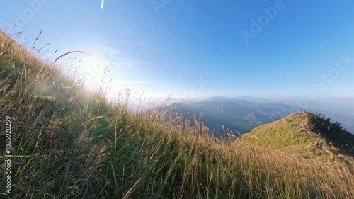 Hilly sunset walking with grass foreground