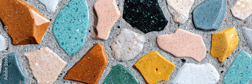 Vibrant terrazzo mosaic background with colorful abstract pattern. This cheerful surface texture shows stone chips in concrete, perfect for interior design and architecture