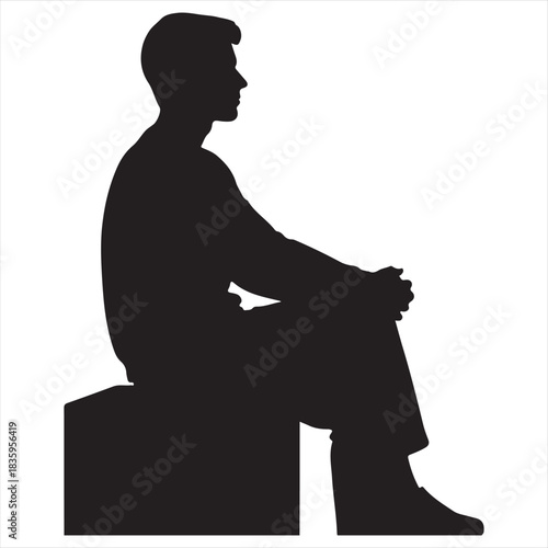 Silhouette of a young man sitting calmly on a dark surface against a white background