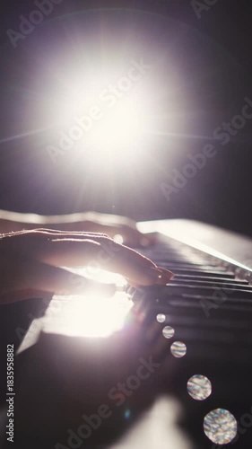 vertical slow motion macro close up of woman playing piano focus on movement of hands and rhythm concept of art of sound creative inspiration elegance and timeless artistic expression