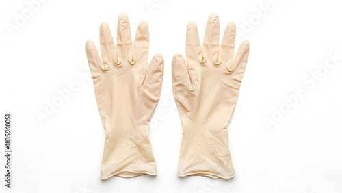Two identical medical gloves, beige in color, laid flat against a stark white backdrop