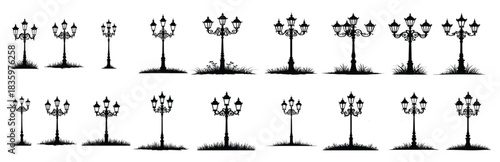 Black silhouette ornate street lamps with grass lamppost