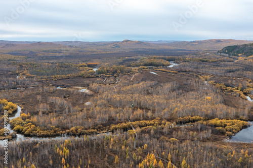 Aerial view of the autumn forest and river in the Shibawan scenic area of ​​Mohe, Greater Khingan Mountains.