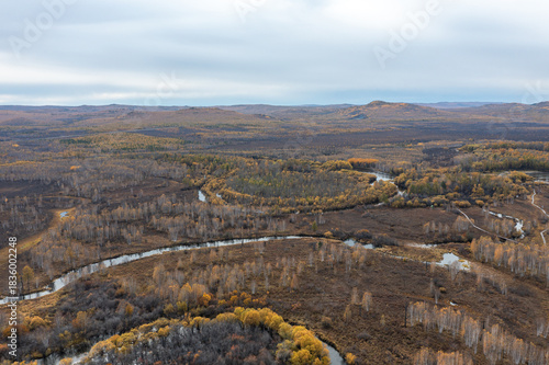 Aerial view of the autumn forest and river in the Shibawan scenic area of ​​Mohe, Greater Khingan Mountains.