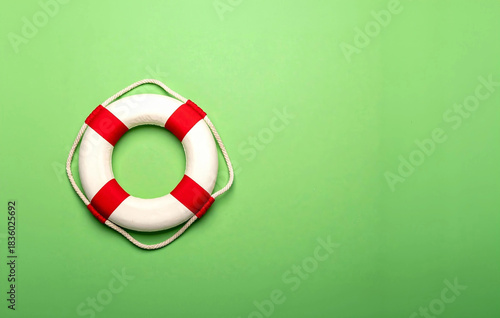 Lifebuoy offering safety and assistance on green background