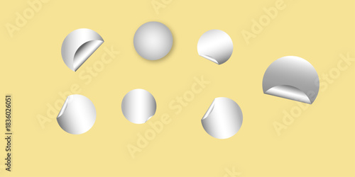 Circle adhesive stickers. White tags, paper round stickers with peeling corner isolated on Light yellow / beige background. Blank blue round stickers with curled corners, realistic mockup .