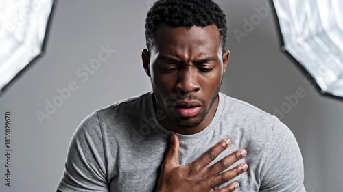 Man Experiencing Chest Pain or Discomfort, Showing Expressions of Distress and Worry