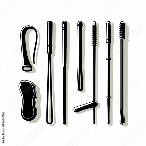 Collection of black cosmetic brushes and applicators on a white background