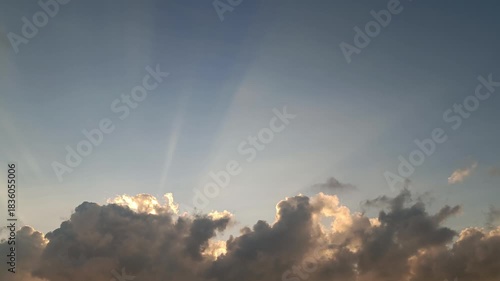 Dramatic Sunset Sky with Powerful Crepuscular Light Rays Bursting Through Dark Clouds