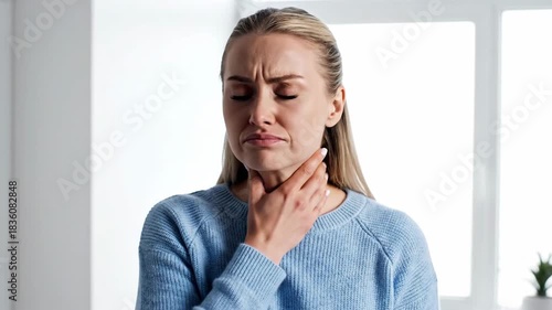 Woman Experiencing Sore Throat, Painful Swallowing, Holding Her Neck, Showing Discomfort.