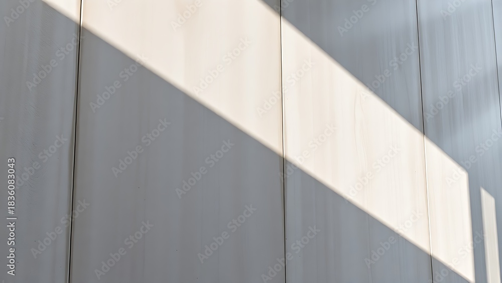 Obraz premium Smooth concrete wall with subtle shadows, emphasizing modern architectural texture.