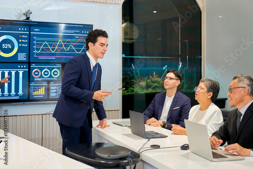Businessman lead the meeting in meeting room with team of senior sales and other.