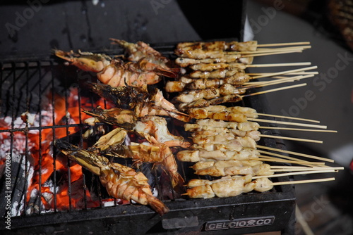 Grilling seafood such as squid and lobster over open flame for dinner preparation — fresh cooking process and flavorful outdoor cuisine