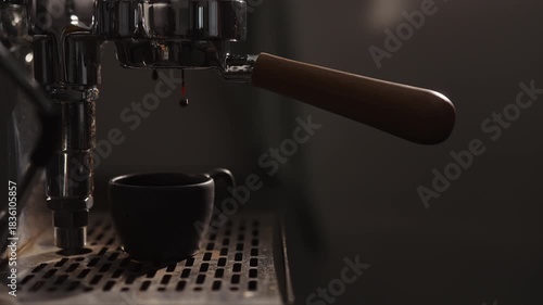 Slow motion dark early morning shot of coffee machine making esprresso