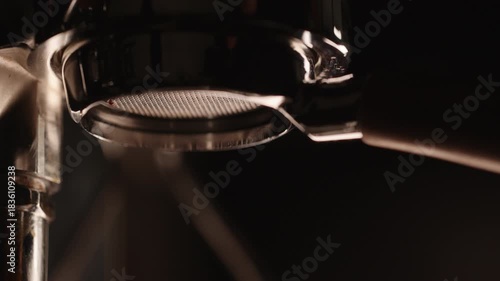 Slow motion pull espresso shot with bottomless portafilter on a professional coffee machine