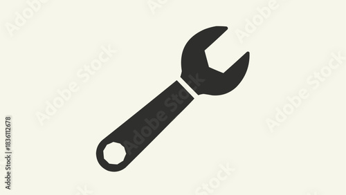 Black silhouette of a wrench tool on a light beige background, representing repair and maintenance.