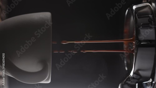 Vertical slow motion pull espresso shot with bottomless portafilter on a professional coffee machine