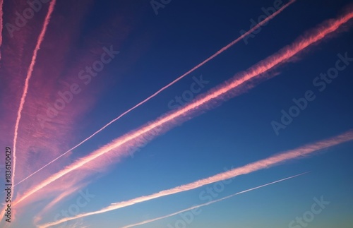 Vivid pink contrails dyed by the sunset