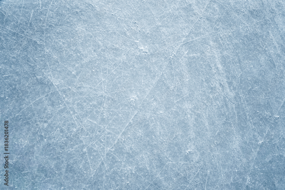 Obraz premium An ice surface as an ice rink with ice skates tracks. Winter sports texture.