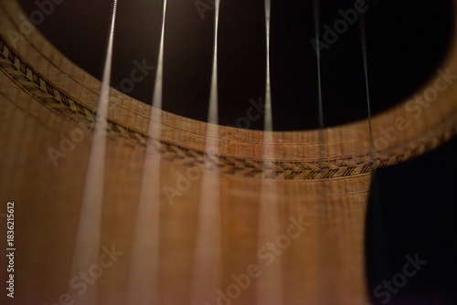 A sharp close-up photograph of an acoustic guitar highlighting its strings, wood texture, and craftsmanship. Ideal for music, instruments, creativity, and artistic product themes.