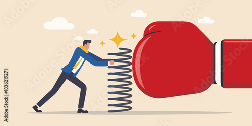 Businessman pushing back against a giant boxing glove with a spring