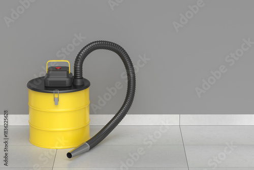 Yellow ash vacuum cleaner on tiled floor in a room