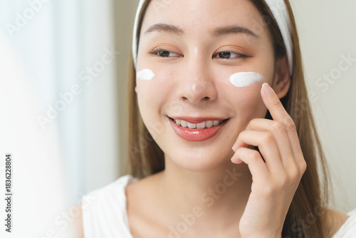 Routine skin care concept, Close-up woman applying cream on her face