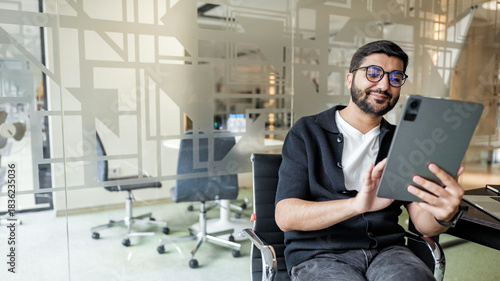 Man using tablet in modern office setting