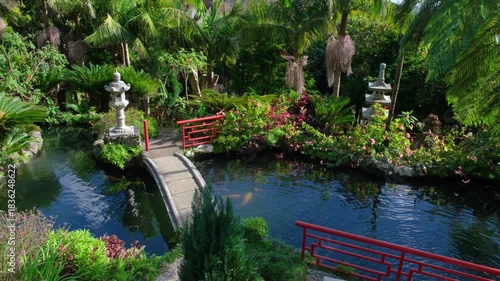 Japanese Monte Palace tropical garden on Madeira with greenery, red bridges, and a koi pond for serene beauty and tranquility
