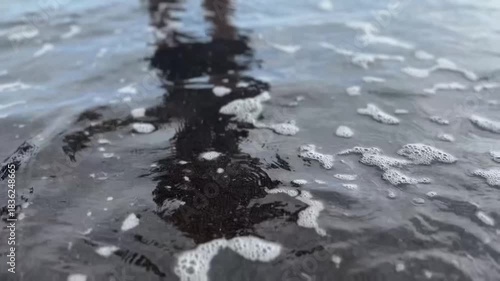 Human Silhouette Reflected on Calm Ocean Surface