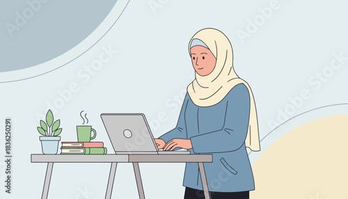 Woman in Hijab Working on Laptop at Desk.