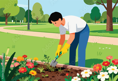 A person in yellow gloves is gardening in a park, tending to colorful flowers with a trowel