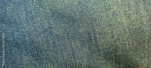 Close-up view of a blue woven textile material showcasing its intricate texture and diagonal pattern, providing a versatile background for design projects and fashion concepts