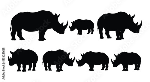 Silhouette of a rhino family walking across a plain nature s majestic creatures