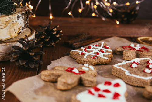 Christmas new year background, traditional festive gingerbread and tangerines with fir branches, cones and decorations, dish design idea, bakery concept,