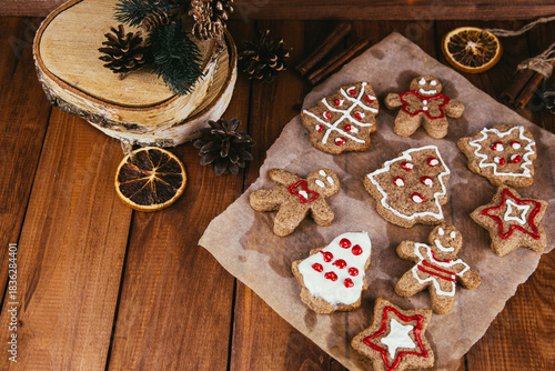 Christmas new year background, traditional festive gingerbread and tangerines with fir branches, cones and decorations, dish design idea, bakery concept,