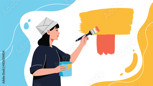 Young woman wearing a paper hat painting a wall yellow with a paintbrush during a home renovation or redecoration project.