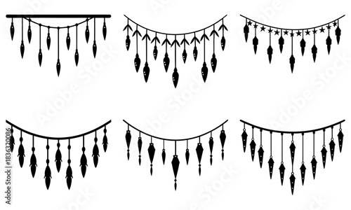 Various black decorative hanging ornaments with tassels and stars on a white background display artfully