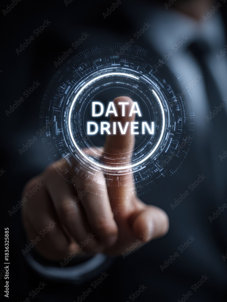 Fototapeta premium businessman touching a futuristic interface with the words data driven in the center symbolizing data analysis and decision making