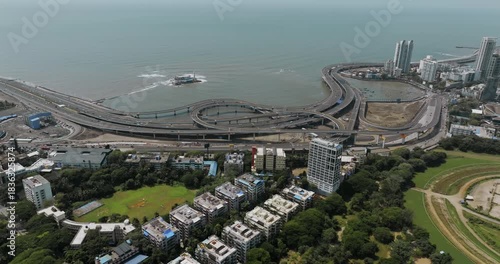 Morning view of the Mumbai Coastal Road in Maharashtra, India, famously known as the 'City of Dreams.' The scene captures a multileveled interchange roadway. A complex road network and urban design.