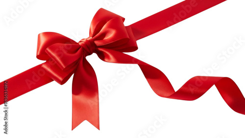 Close up of a vibrant red satin ribbon tied into a bow on a dark background, angled view