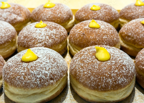 Vanilla Cream filled doughnuts dusted with powdered sugar