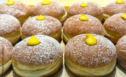 Vanilla Cream filled doughnuts dusted with powdered sugar