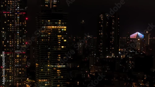 Wallpaper Mural An aerial view of Mumbai's high-rise buildings and beautiful nightlights. The sky is cloudy, and there is medium traffic on the road. The cityscape is filled with modern illuminated buildings. Torontodigital.ca