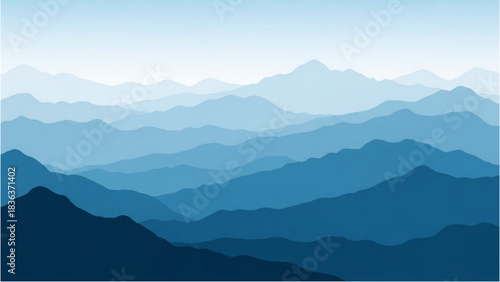 A tranquil and serene panoramic view of layered blue mountain ranges