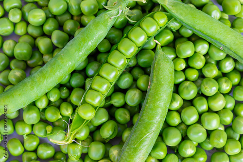 Fresh green peas and open pods displayed in a vibrant close-up, ideal for food packaging, recipe visuals, farming promotions, healthy diet campaigns, nutrition blogs, organic product ads.