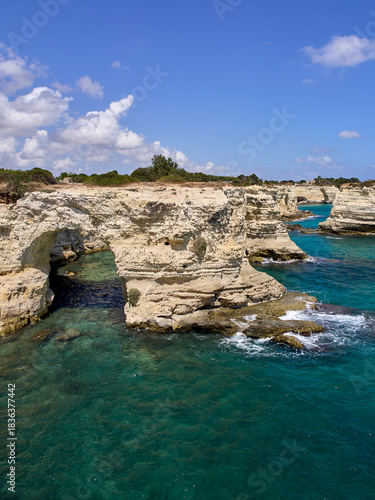 Limestone arch and crystalline turquoise water in the Adriatic sea. Torre Sant'Andrea. Melendugno, province of Lecce, Salento, Apulia, Puglia, Italy, Europe