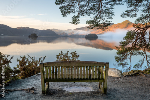 Wooden bench at Friars Crag with beautiful winter views of Derwentwater. Keswick, Lake District, UK.